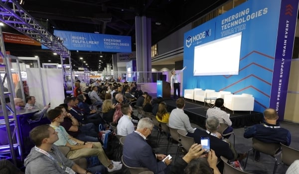 A large group of MODEX attendees listening to a speaking session